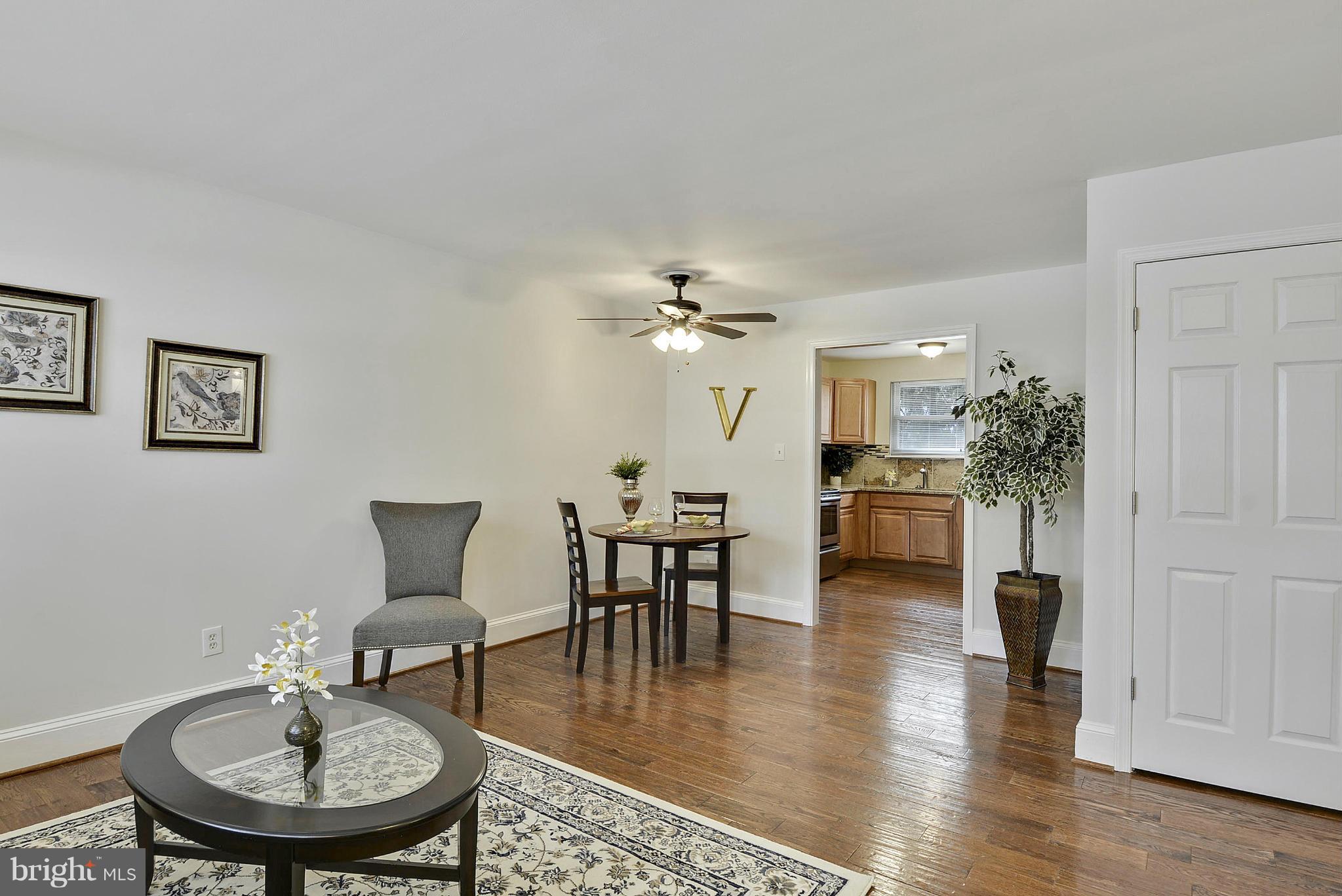 106 Harmony Hall Road Gaithersburg, MD 20877 - Photo 5 of 30 a dining room with furniture and wooden floor