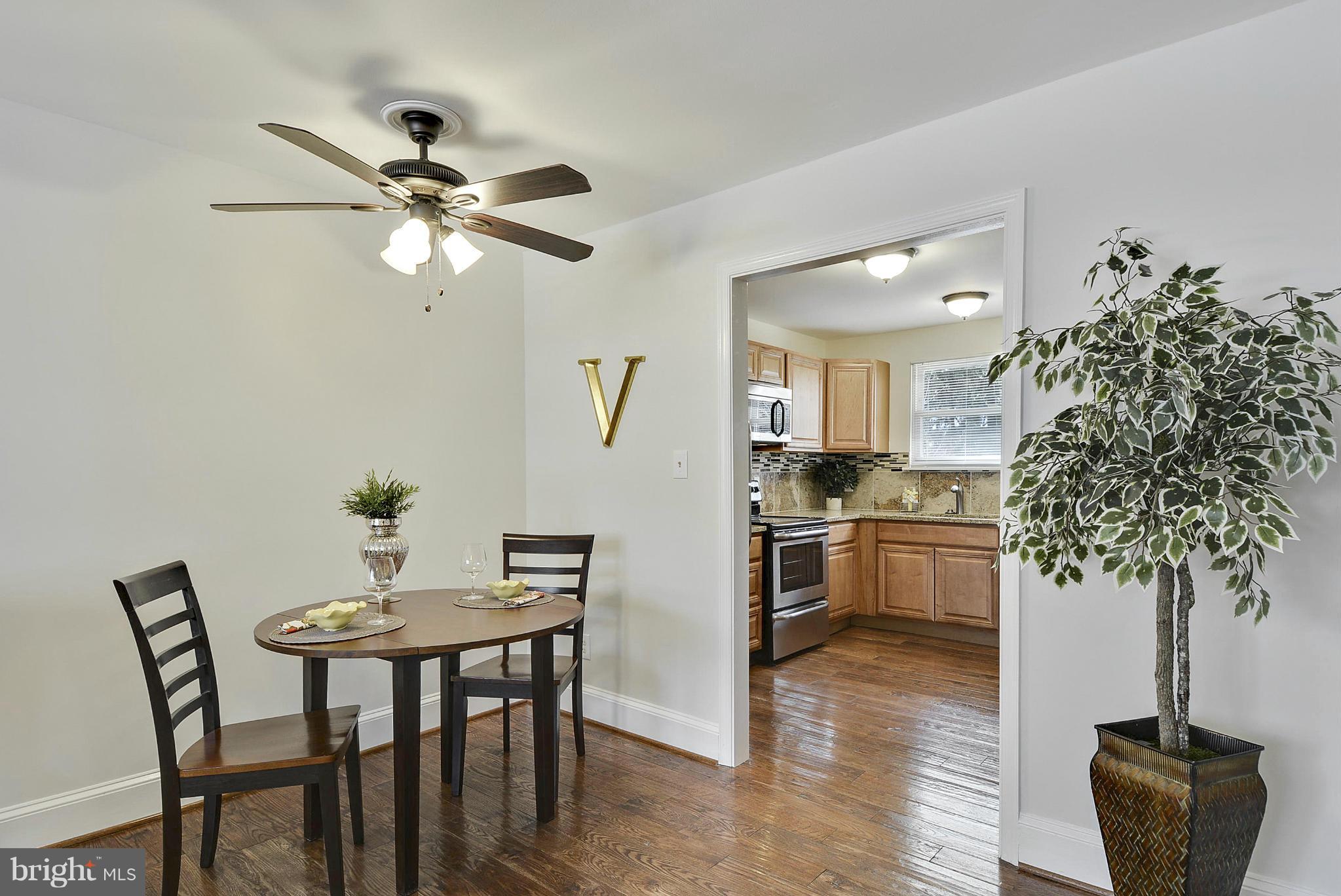 106 Harmony Hall Road Gaithersburg, MD 20877 - Photo 8 of 30 a view of a dining room with furniture and wooden floor
