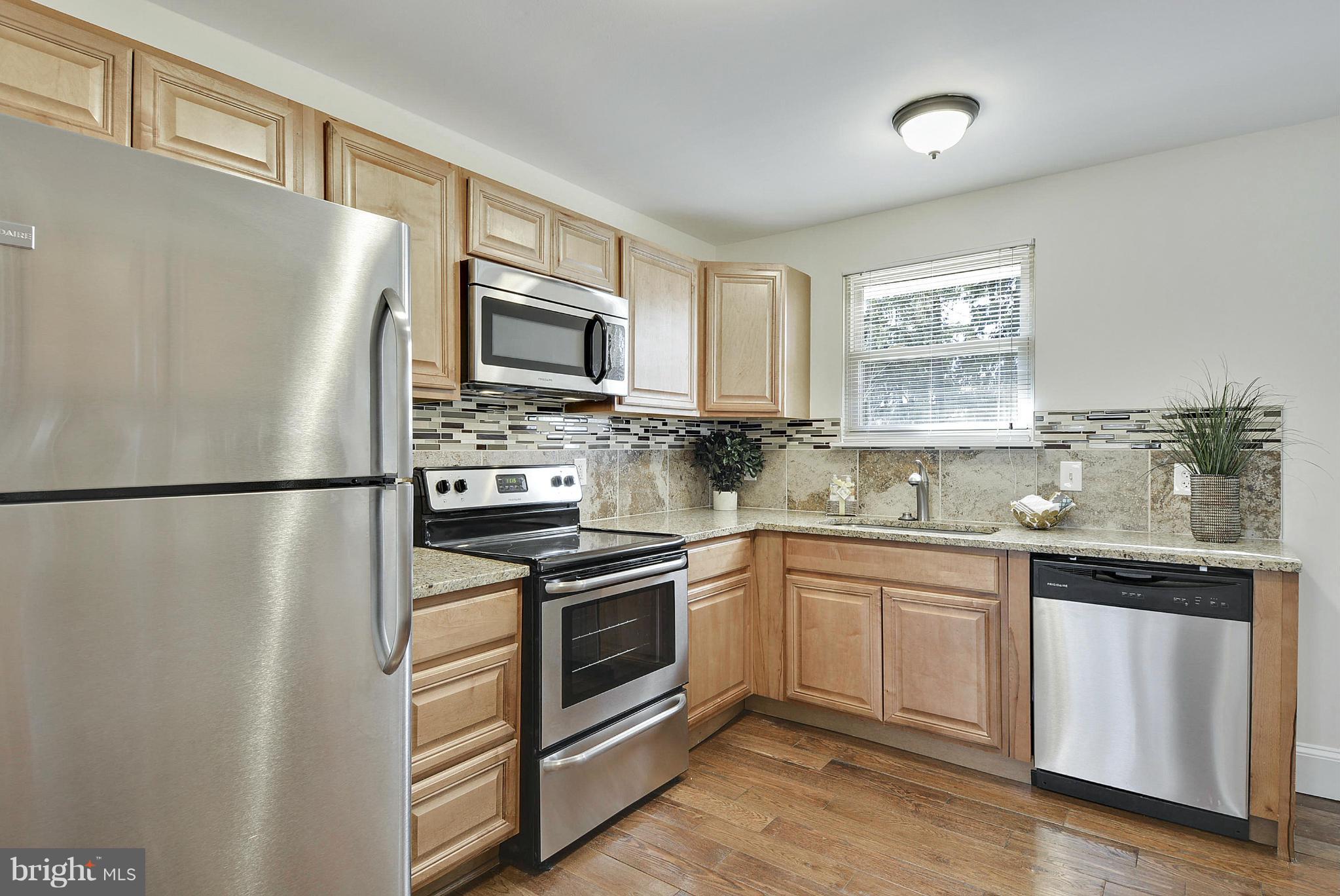 106 Harmony Hall Road Gaithersburg, MD 20877 - Photo 9 of 30 a kitchen with a refrigerator sink and microwave