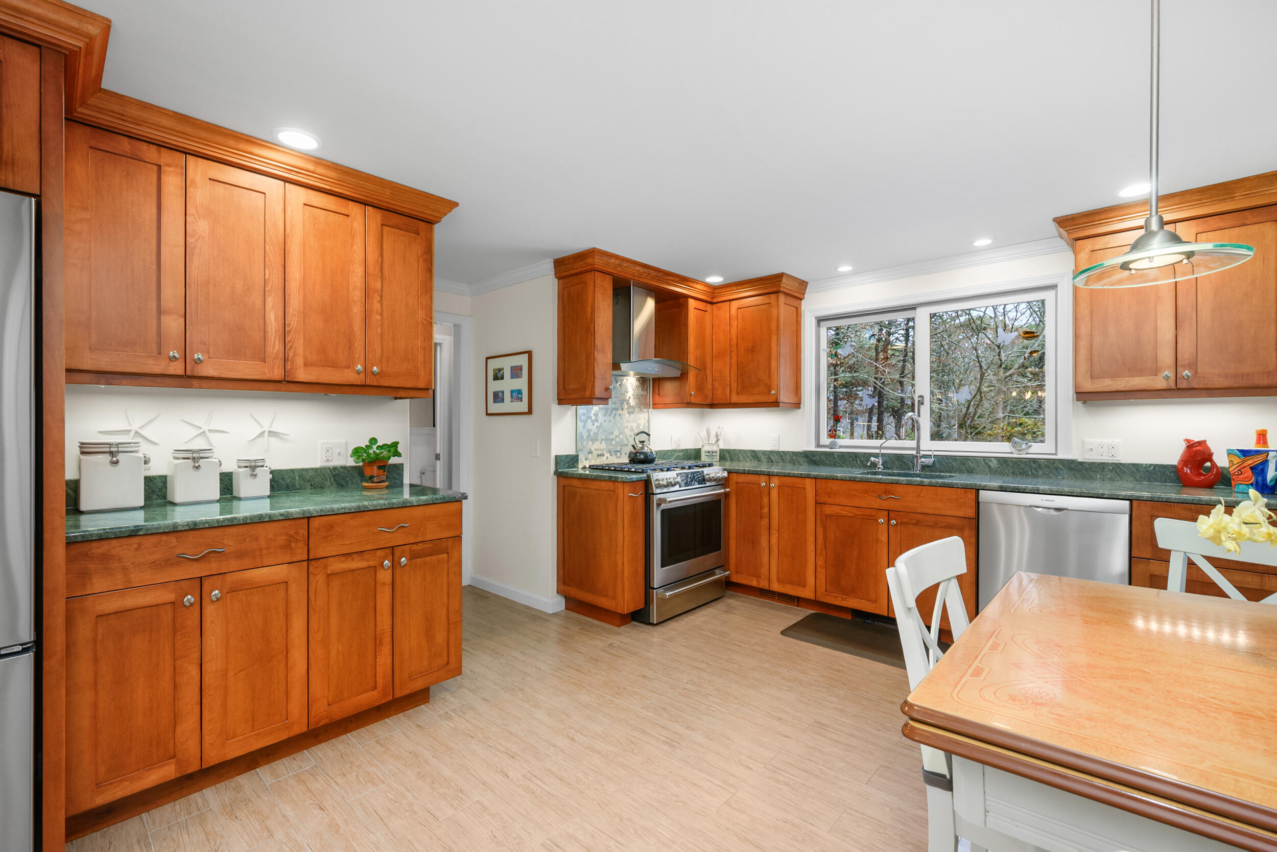 28 Lakeview Avenue Chatham, MA 02633 - Photo 12 of 63 a kitchen with stainless steel appliances granite countertop a sink dishwasher stove top oven and cabinets