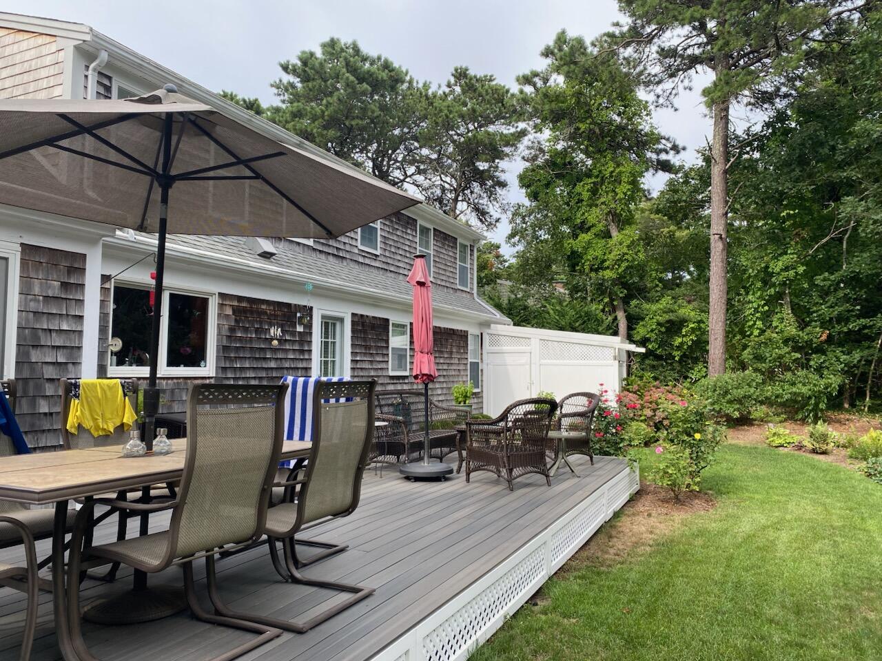 28 Lakeview Avenue Chatham, MA 02633 - Photo 39 of 63 a view of a patio with table and chairs under an umbrella