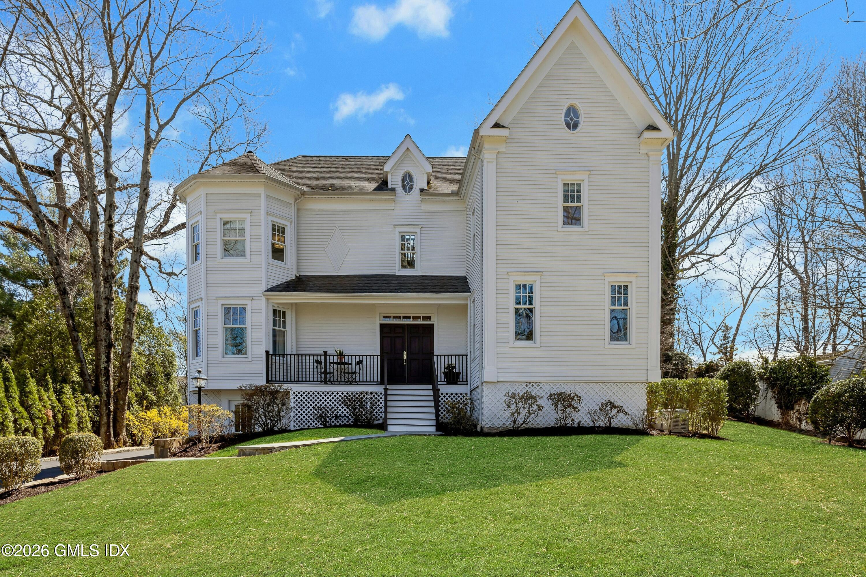 16 Summit Road Riverside, CT 06878 - Photo 5 of 34 a front view of a house with a garden
