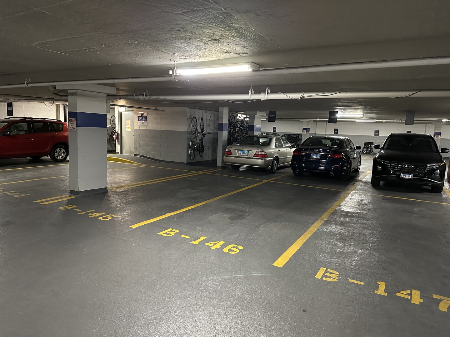 a view of parking garage with cars parked