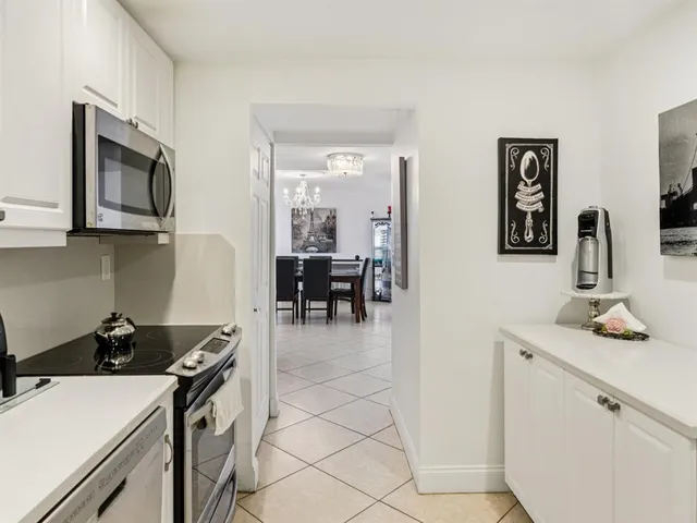 a kitchen with a sink and a stove top oven with wooden floor