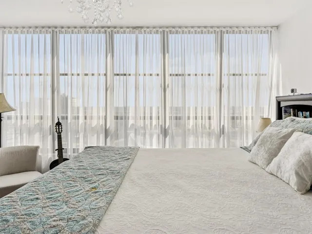 a spacious bedroom with a bed and a couch