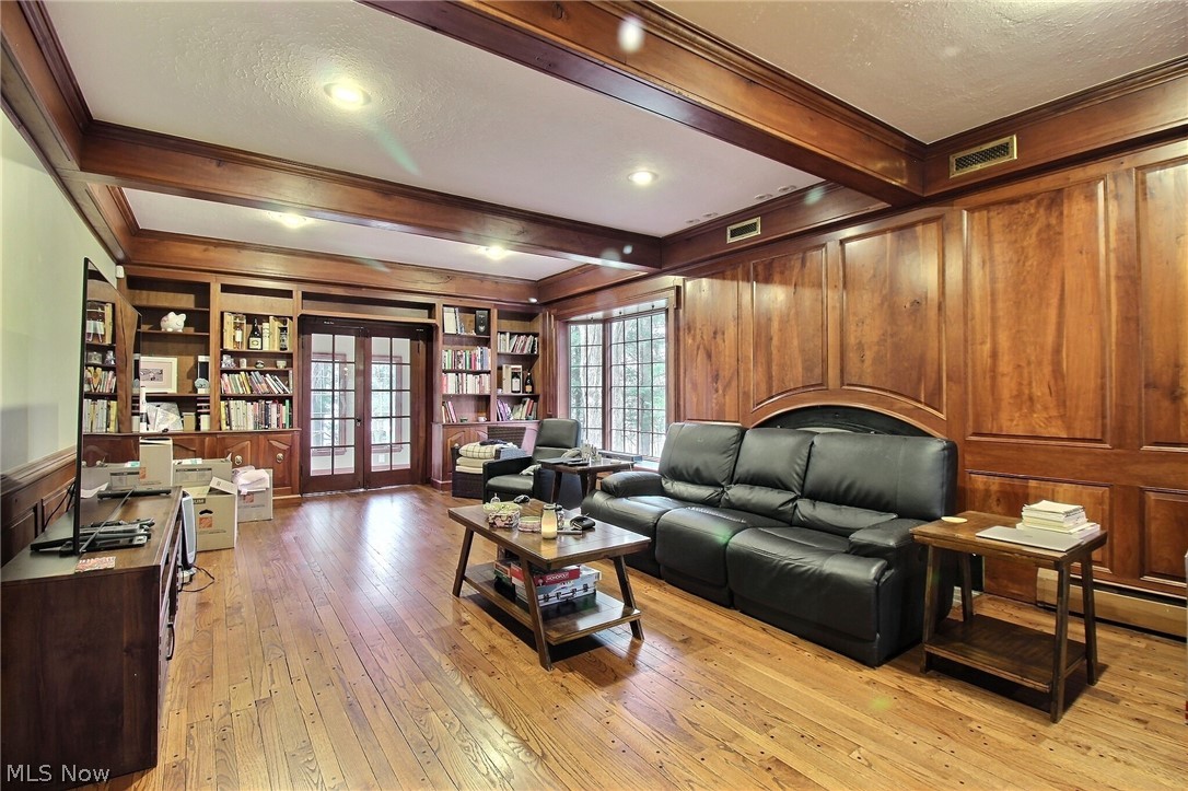 6715 Eagle Road Willoughby, OH 44094 - Photo 4 of 22 Family room featuring crown molding, french doors and wood flooring