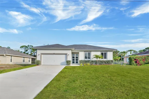 a front view of house with yard and green space
