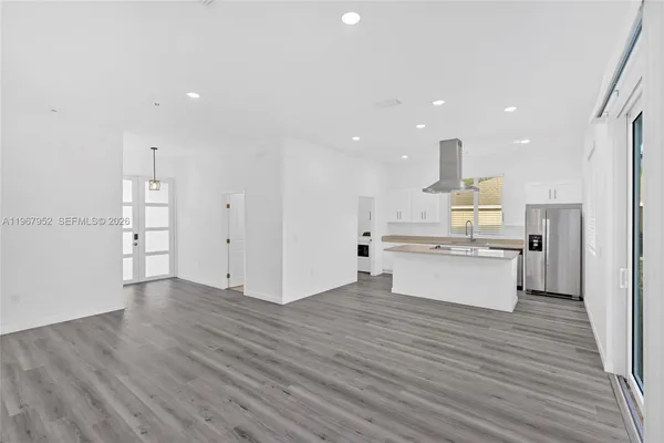 a large kitchen with a lot of counter space and stainless steel appliances