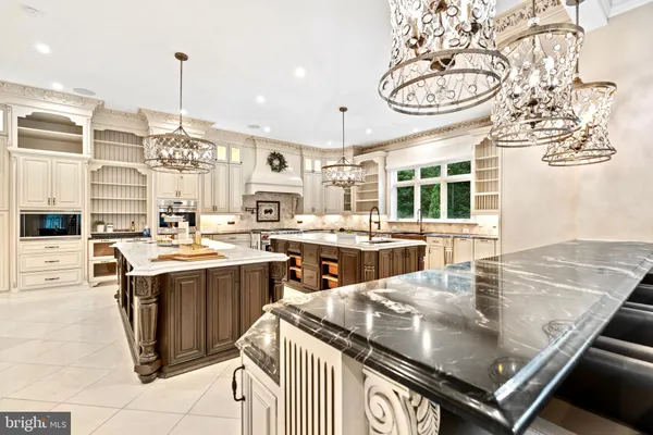 a kitchen with a stove and a view of living room