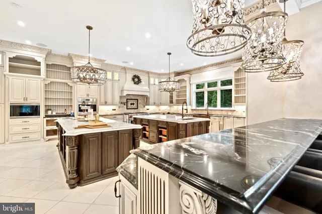 a kitchen with a stove and a view of living room