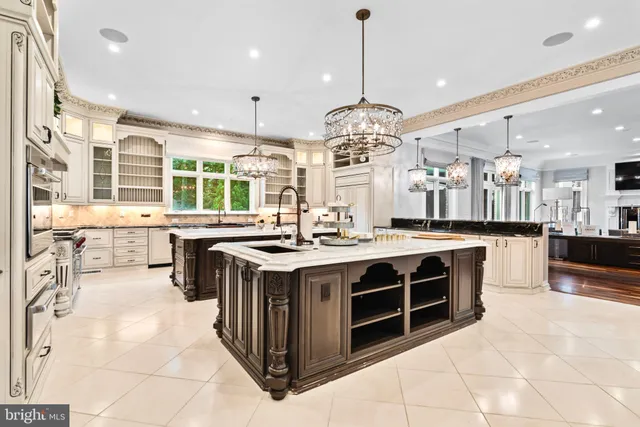 a large kitchen with a counter space a sink stainless steel appliances and cabinets