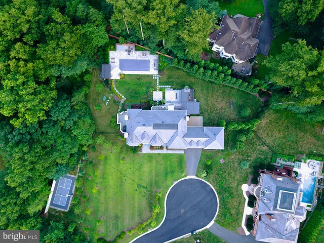 an aerial view of a house with outdoor space swimming pool and trees
