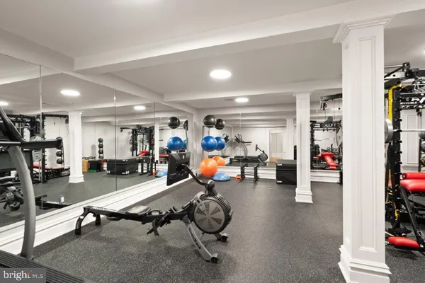 a living room with furniture and gym equipment