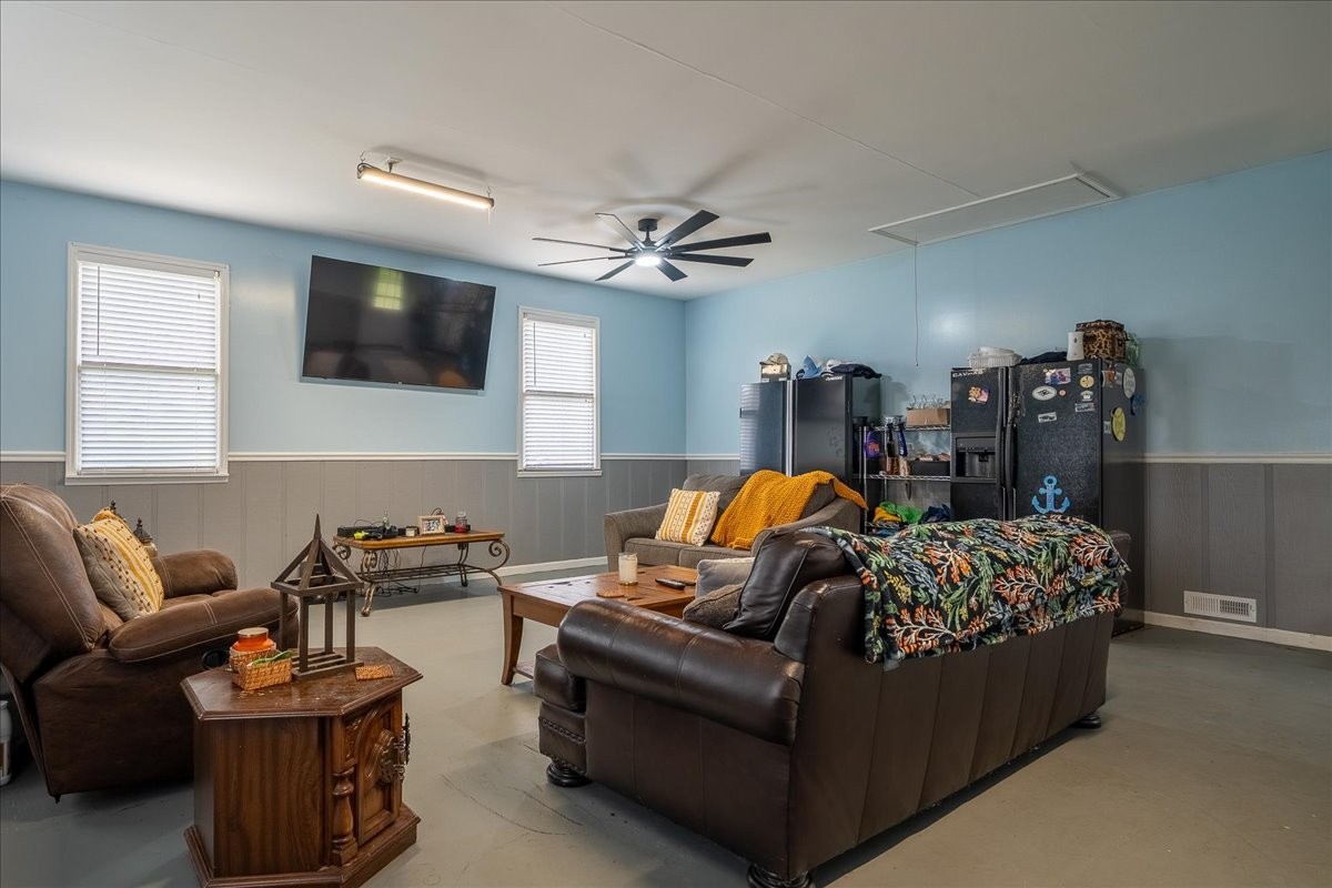79 French Road Loretto, TN 38469 - Photo 31 of 52 a living room with furniture a flat screen tv and a chandelier
