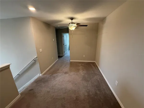 a view of a chandelier fan and hardwood floor