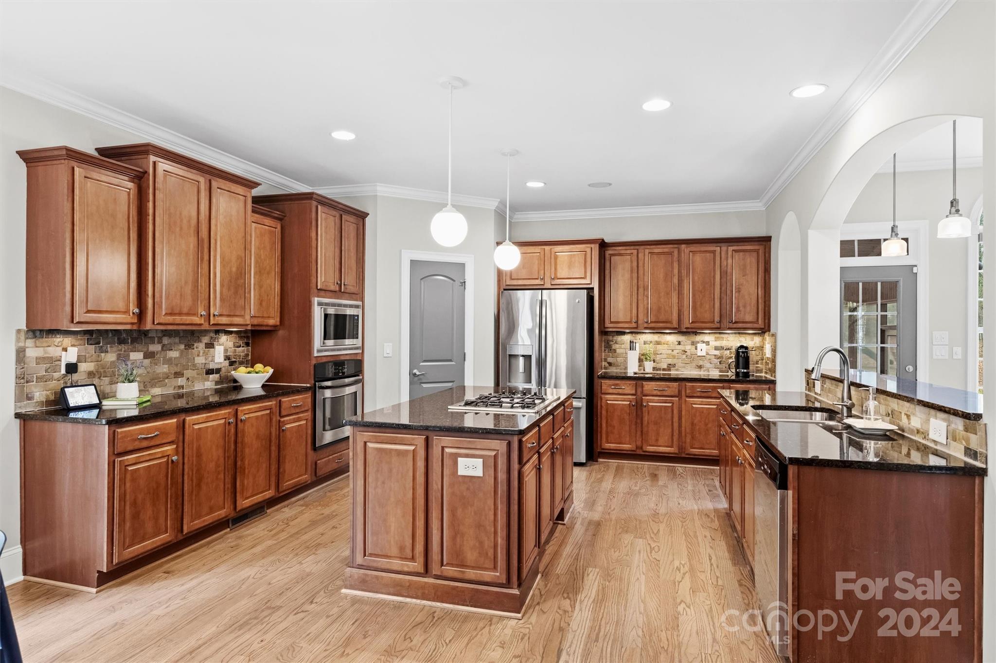 7019 Montgomery Road Lake Wylie, SC 29710 - Photo 20 of 48 a kitchen with stainless steel appliances granite countertop lots of counter top space and wooden floor