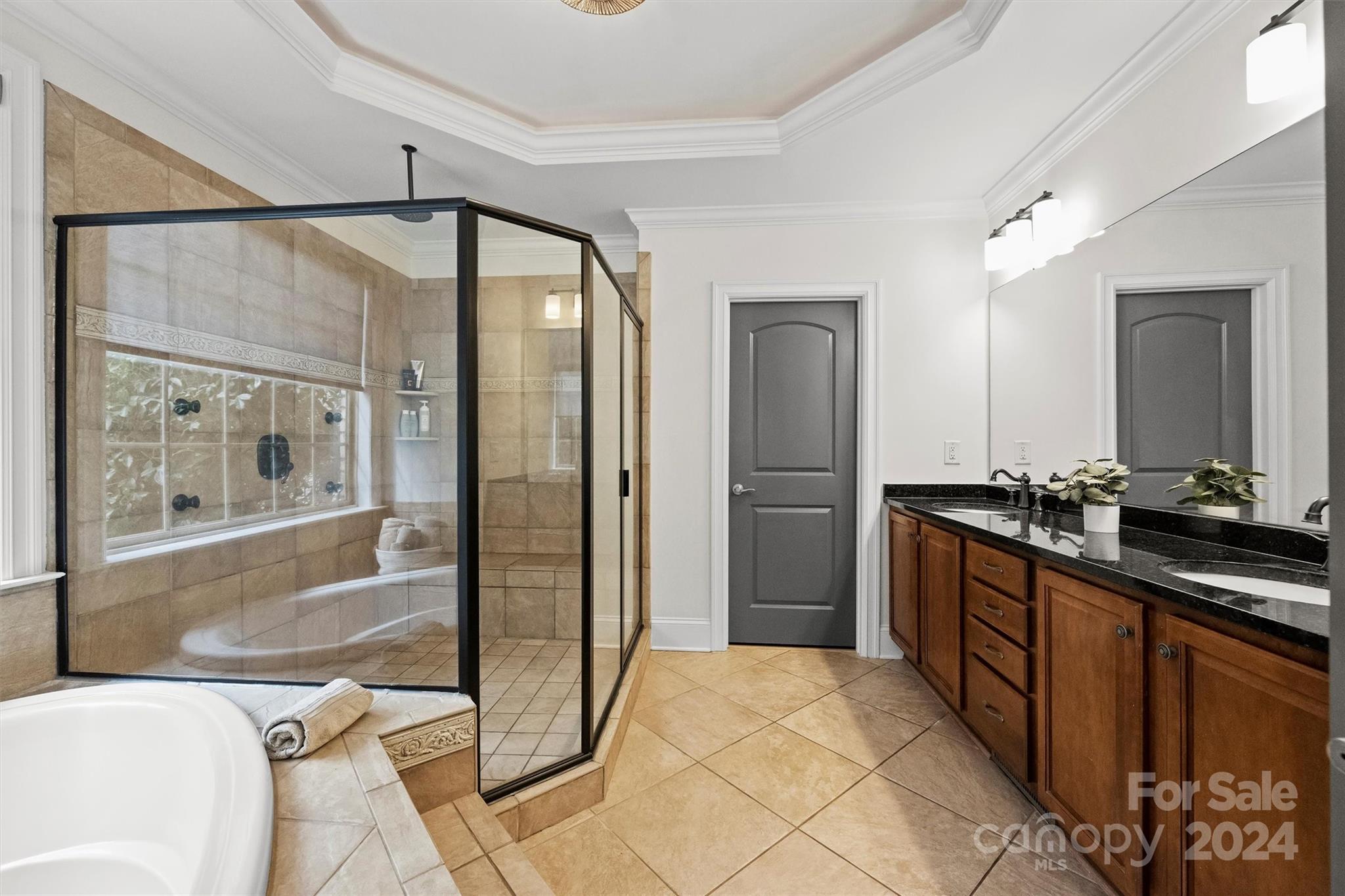 7019 Montgomery Road Lake Wylie, SC 29710 - Photo 23 of 48 a large bathroom with a glass shower door and a mirror