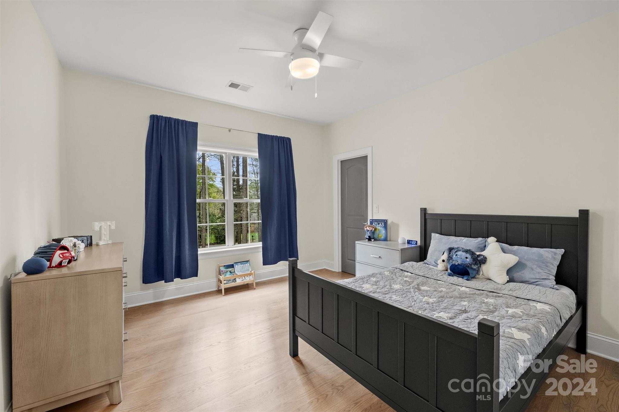 7019 Montgomery Road Lake Wylie, SC 29710 - Photo 31 of 48 a bedroom with a large bed and a chandelier