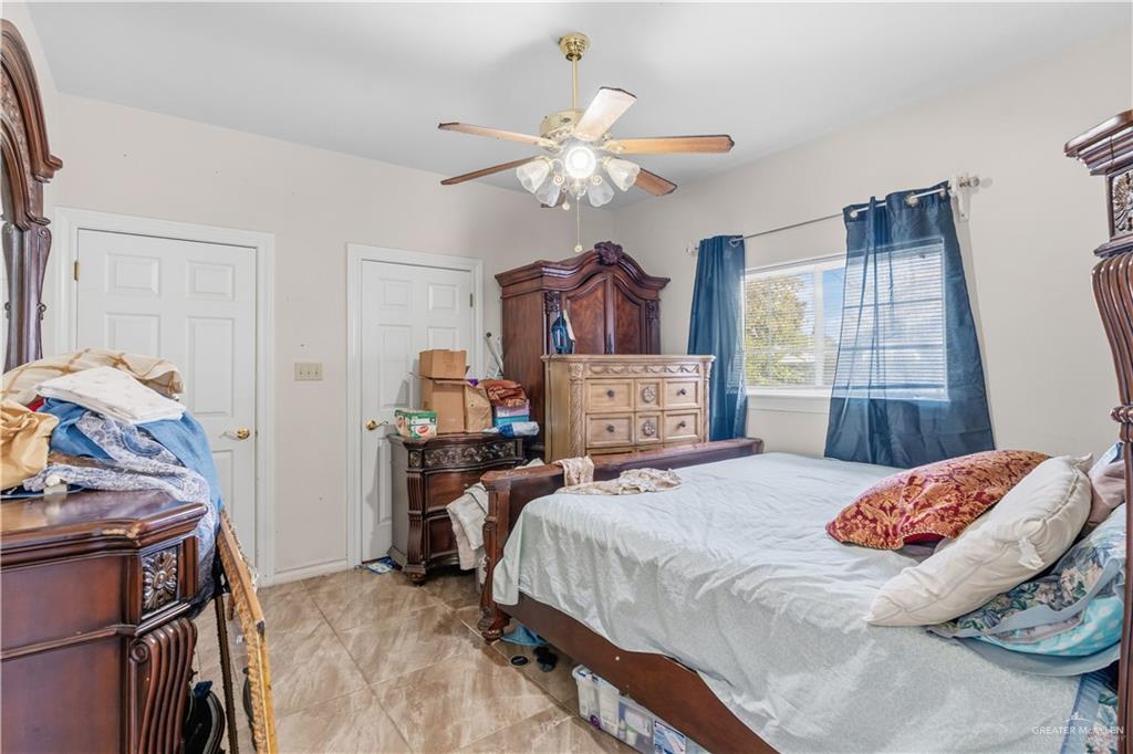 1315 Rio Comal Circle San Juan, TX 78589 - Photo 13 of 16 a bedroom with a bed and a chandelier