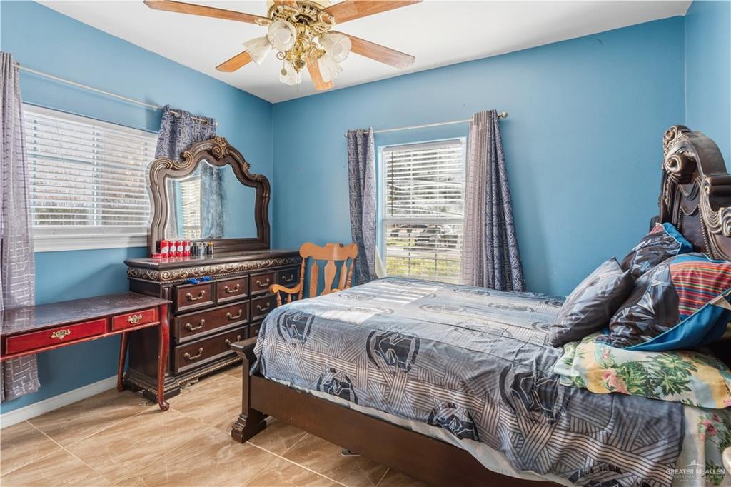 1315 Rio Comal Circle San Juan, TX 78589 - Photo 15 of 16 a bedroom with a bed and a chandelier