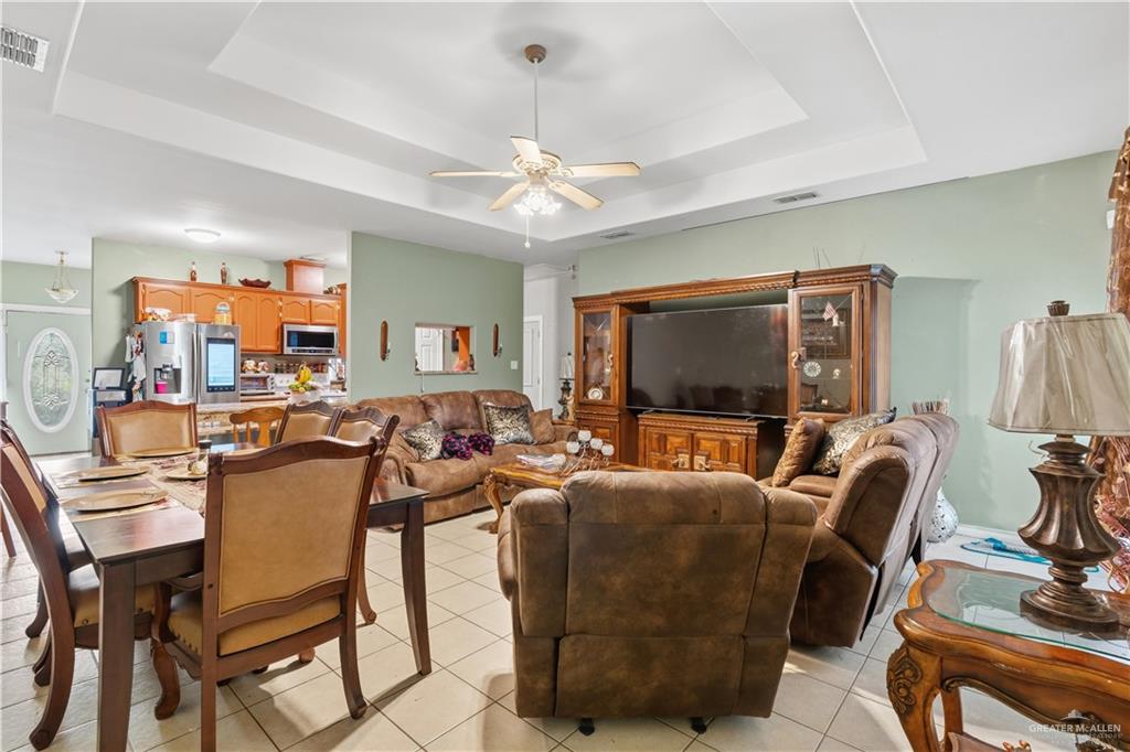 1315 Rio Comal Circle San Juan, TX 78589 - Photo 3 of 16 a living room with furniture a flat screen tv and kitchen view
