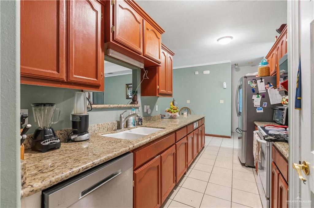 1315 Rio Comal Circle San Juan, TX 78589 - Photo 5 of 16 a kitchen with granite countertop a sink and cabinets