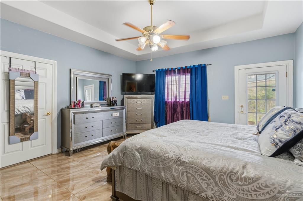 1315 Rio Comal Circle San Juan, TX 78589 - Photo 9 of 16 a bedroom with a bed dresser and a flat screen tv