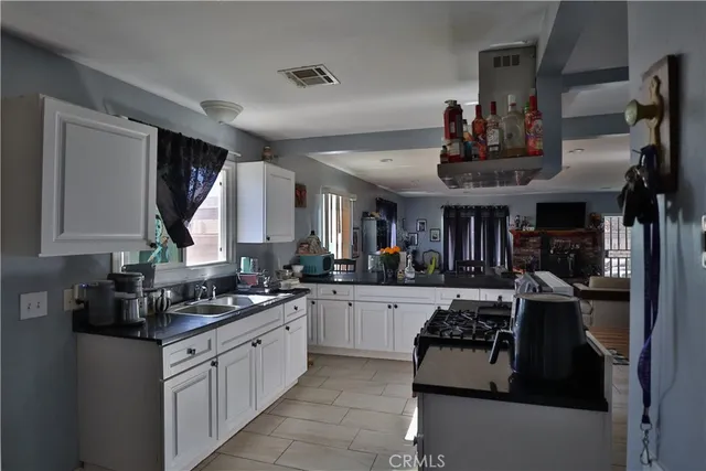 a kitchen with stainless steel appliances granite countertop a stove and cabinets