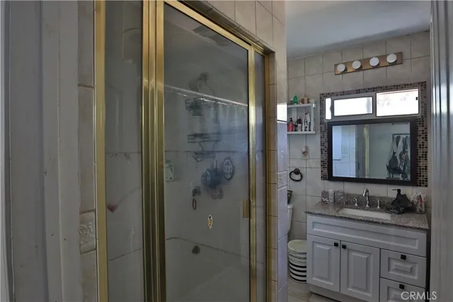 a bathroom with a granite countertop sink mirror and double