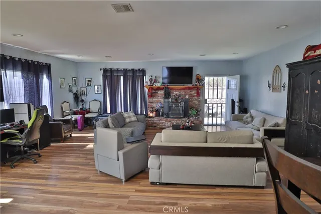 a living room with furniture flat screen tv and large window