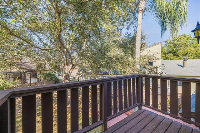 a balcony with wooden floor and fence
