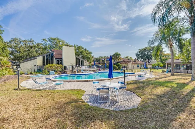 a view of a house with swimming pool and sitting area