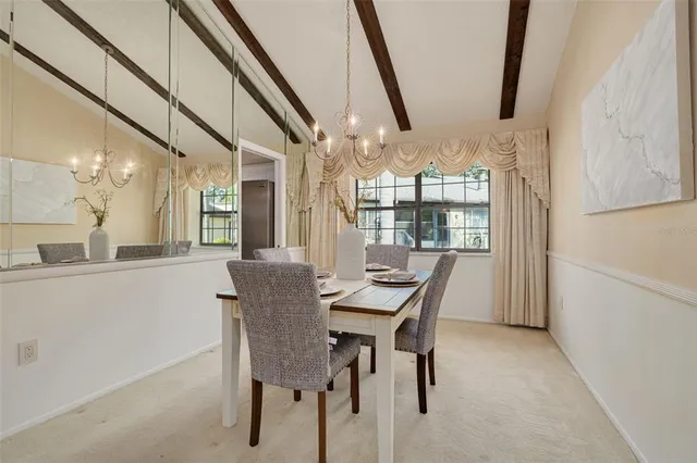 a view of a dining room with furniture and window