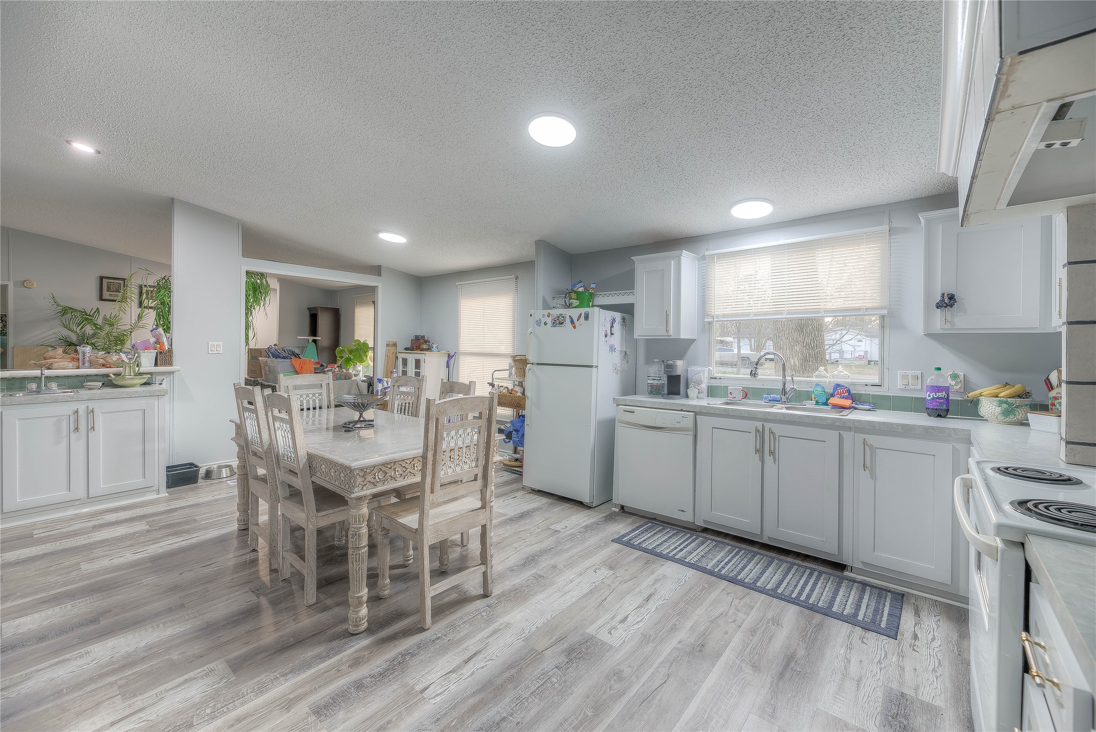 17709 Pine View Drive Conroe, TX 77302 - Photo 14 of 26 a kitchen with a sink window and chairs