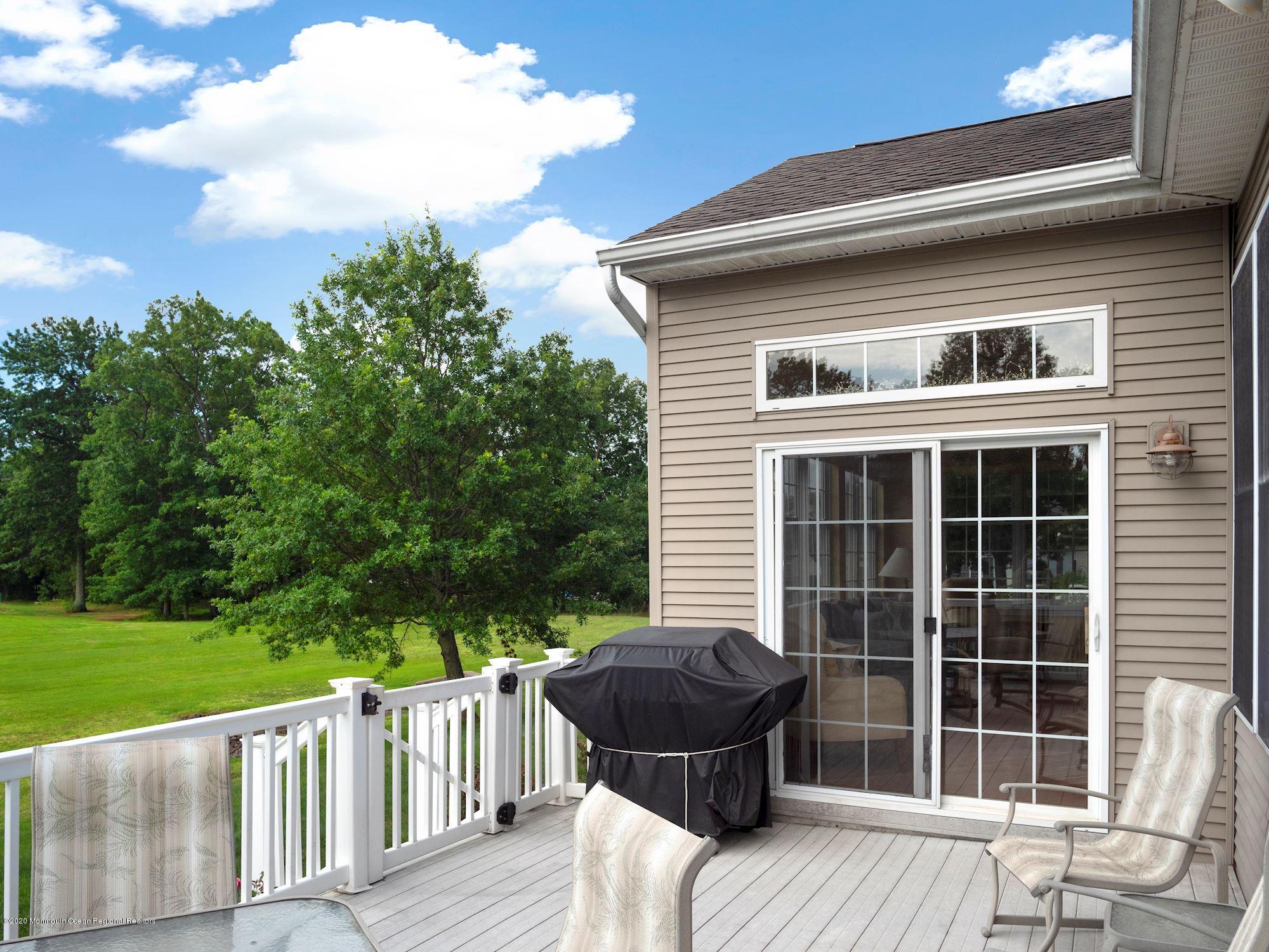 15 Winged Foot Road Jackson, NJ 08527 - Photo 14 of 34 a view of a deck with a floor to ceiling window next to a yard