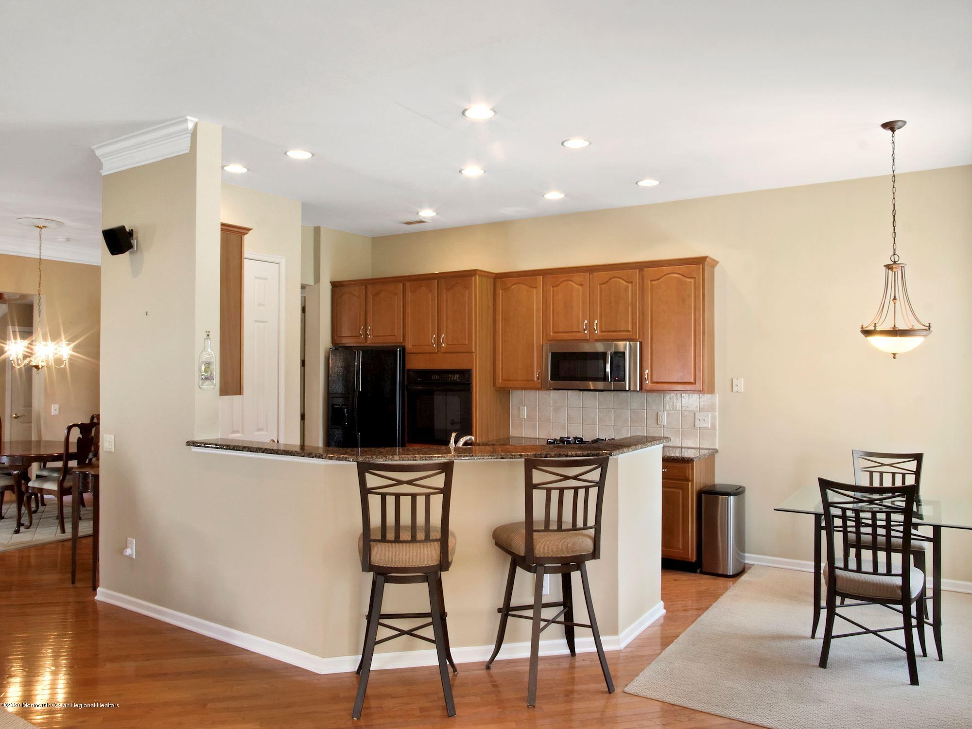 15 Winged Foot Road Jackson, NJ 08527 - Photo 19 of 34 a kitchen with stainless steel appliances kitchen island granite countertop a table and chairs