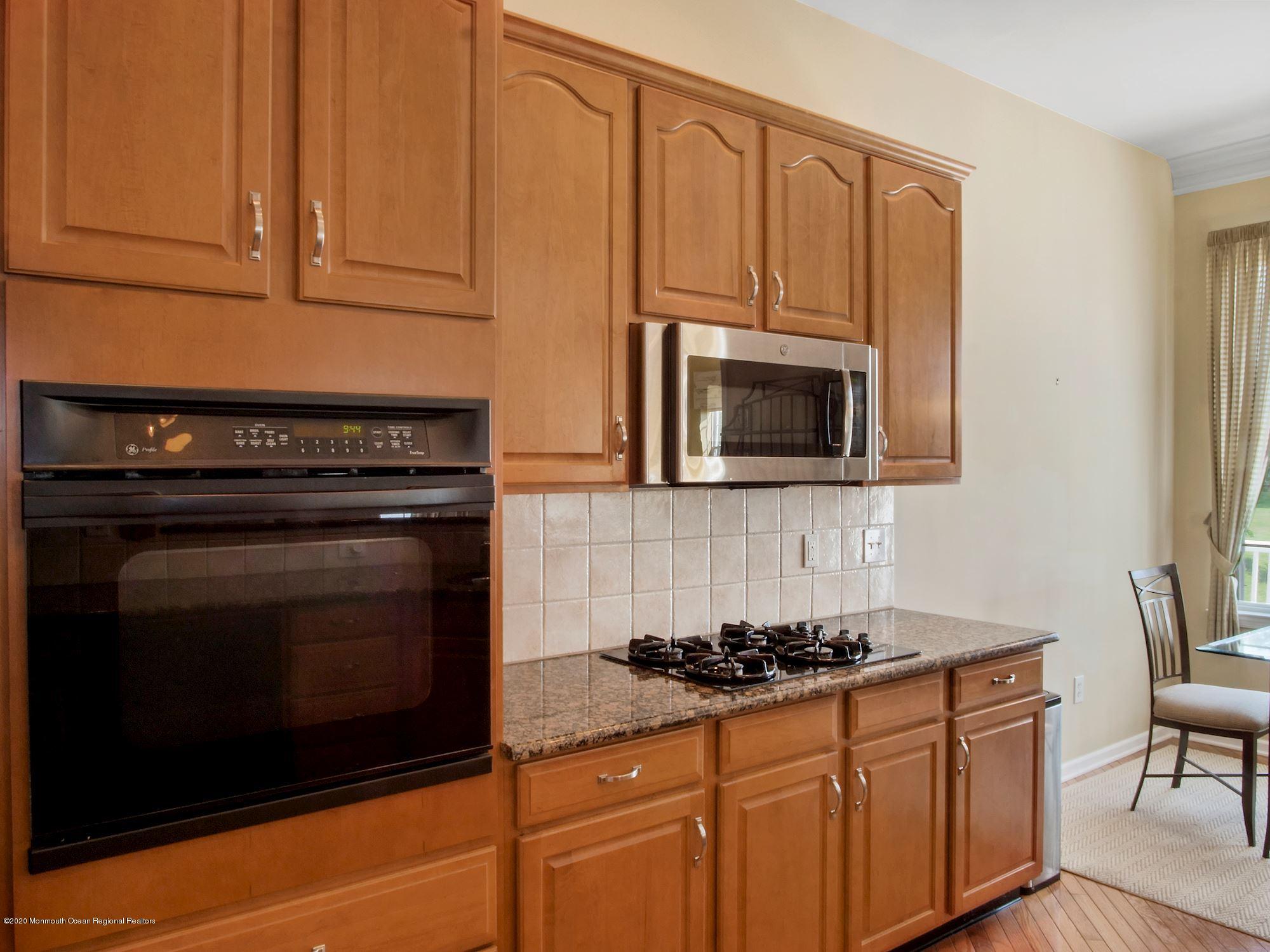 15 Winged Foot Road Jackson, NJ 08527 - Photo 20 of 34 a kitchen with granite countertop cabinets stainless steel appliances and wooden cabinets