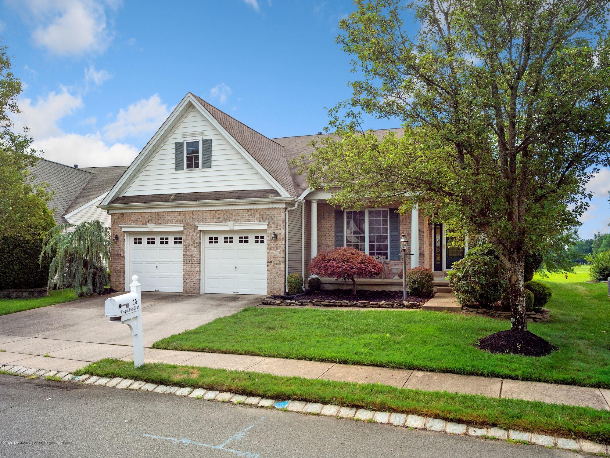 15 Winged Foot Road Jackson, NJ 08527 - Photo 2 of 34 a front view of a house with a yard and garage