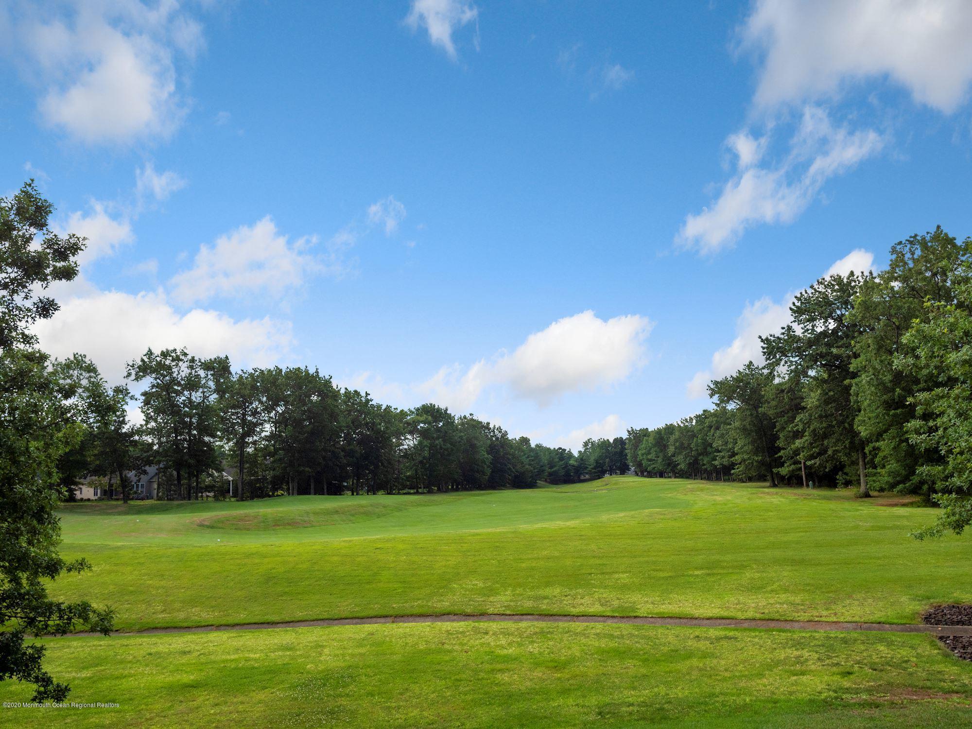 15 Winged Foot Road Jackson, NJ 08527 - Photo 10 of 34 a view of a golf course with a lake