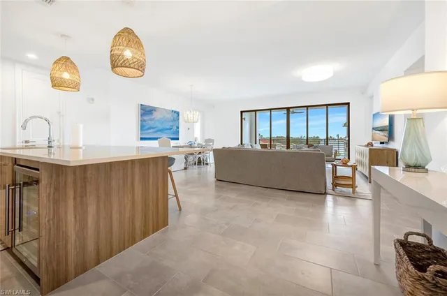 a living room with couches chairs and dresser