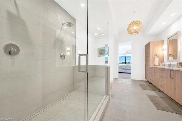 a bathroom with a glass shower door and a sink