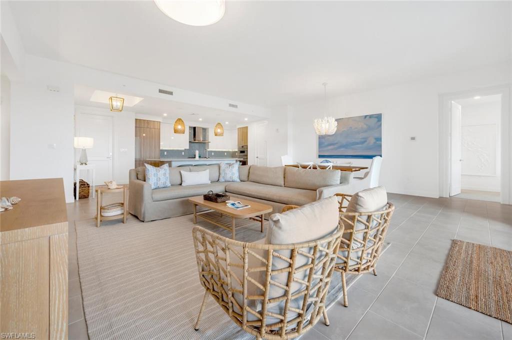 1125 Central Avenue, Unit 477 Naples, FL 34102 - Photo 5 of 48 a living room with furniture and a wooden floor
