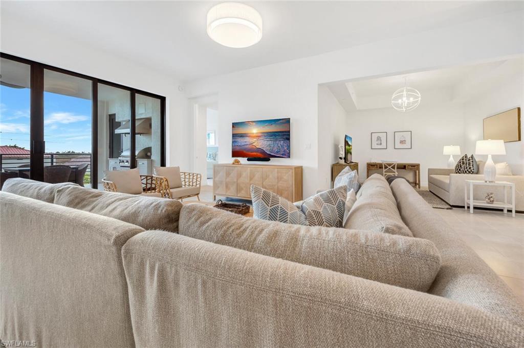 1125 Central Avenue, Unit 477 Naples, FL 34102 - Photo 6 of 48 a living room with furniture and a large window