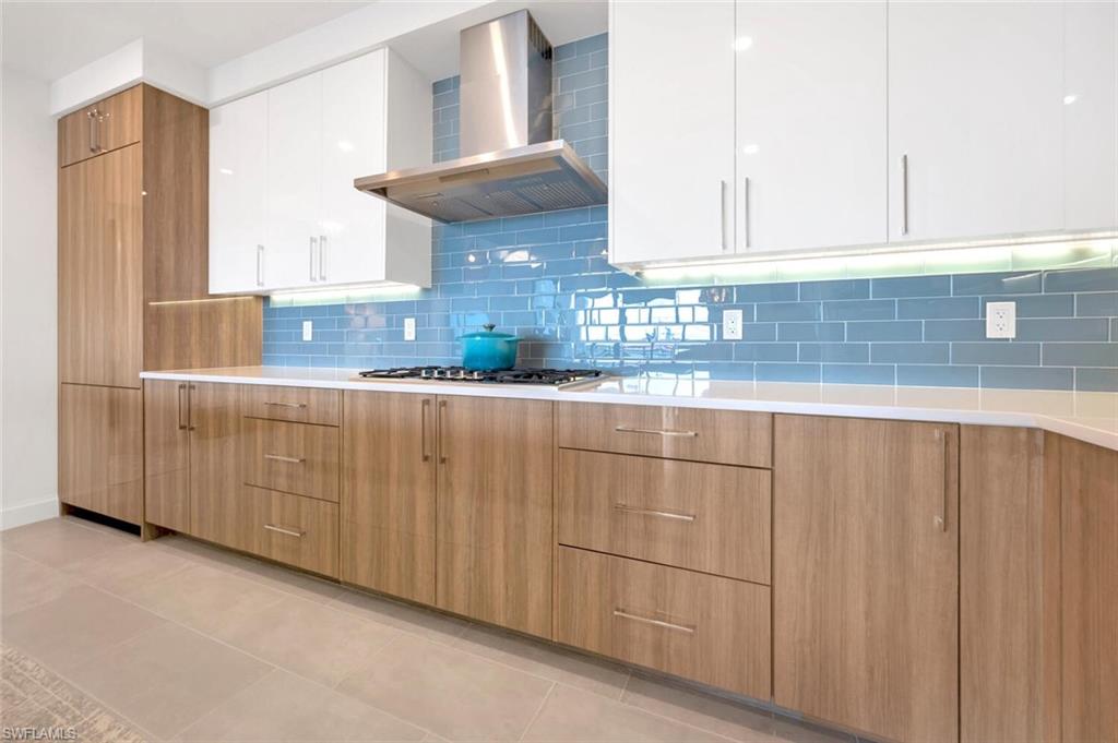 1125 Central Avenue, Unit 477 Naples, FL 34102 - Photo 10 of 48 a kitchen with stainless steel appliances granite countertop a sink and cabinets