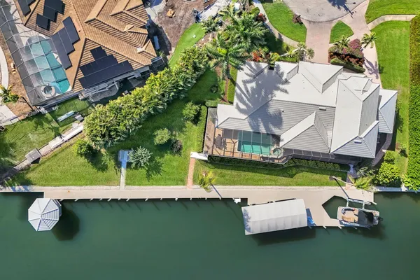 an aerial view of a house with garden space and sitting area