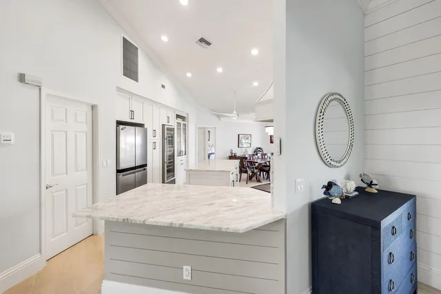 a spacious bathroom with a granite countertop sink a mirror and a shower