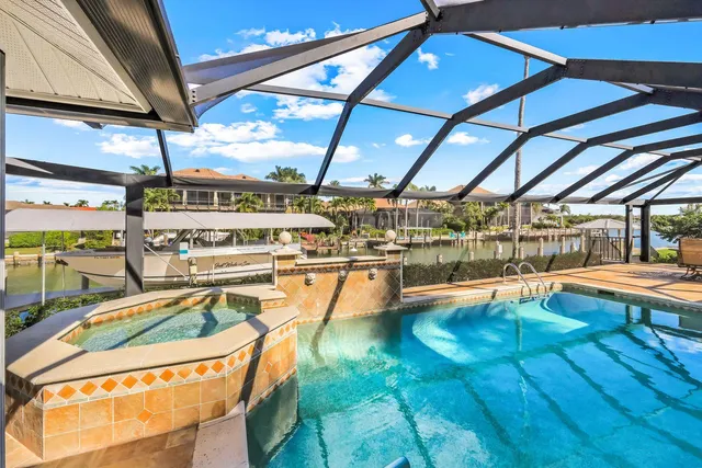 a view of a swimming pool with a patio and a yard