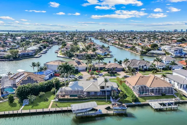 an aerial view of residential houses with outdoor space and lake view
