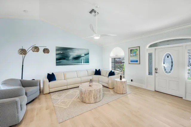 a living room with furniture a window and a flat screen tv