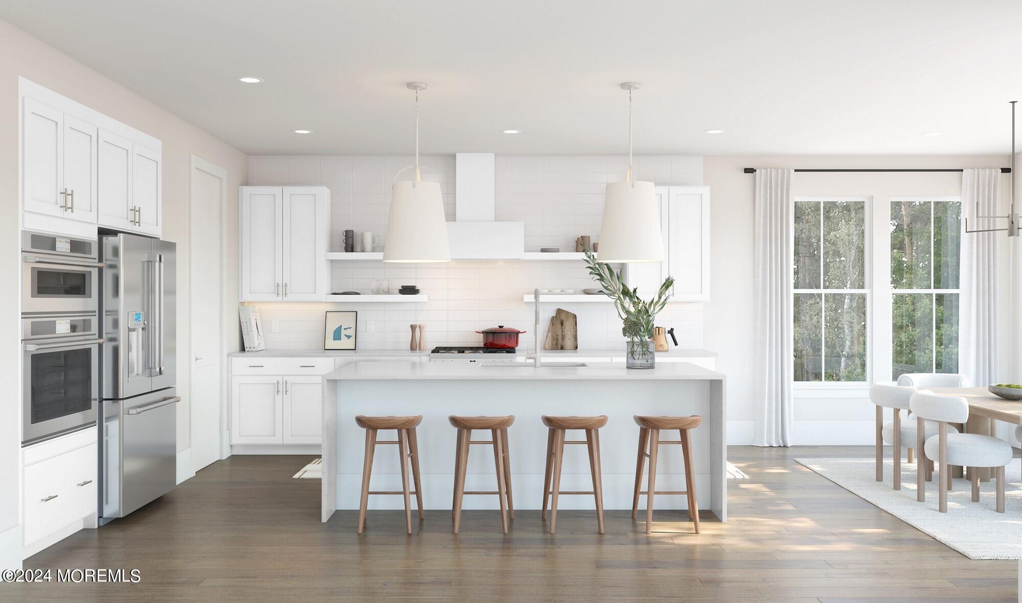 35 Carlisle Court Howell, NJ 07731 - Photo 7 of 14 a kitchen with a table chairs refrigerator and cabinets